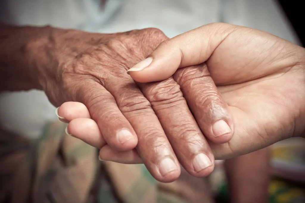 A Picture of two people holding hands.